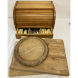 A pine tambour fronted bread bin with under tray containing a collection of vintage cutlery.