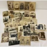 A box of assorted vintage photographs and cabinet cards.