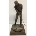 A large brushed effect cast metal figurine of a golfer.