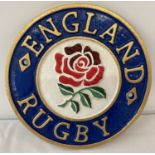 A painted cast metal circular shaped England Rugby wall plaque