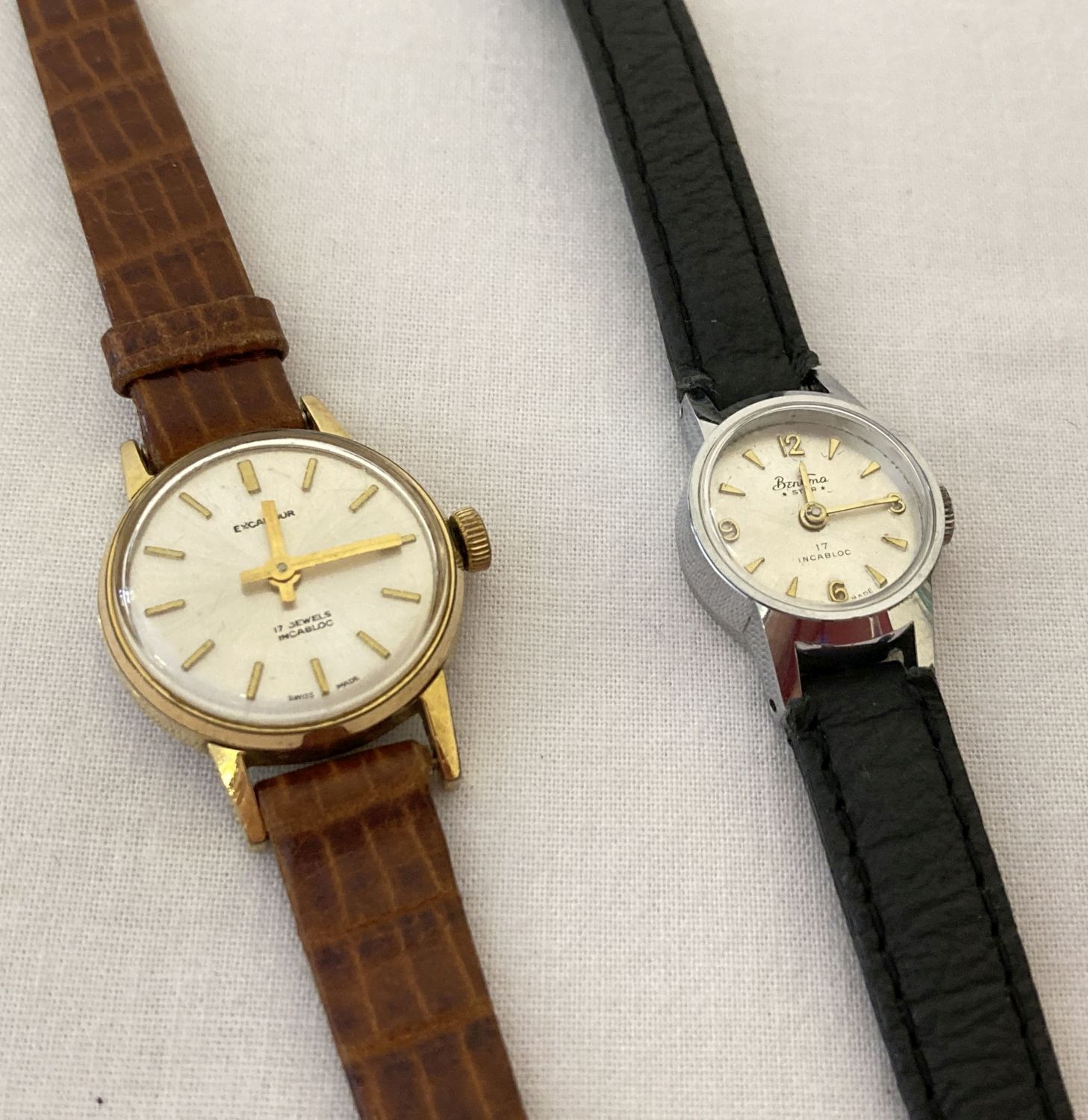 2 ladies vintage wristwatches. An Excalibur with white dial and gold tone hands and hour markers.