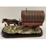 A boxed resin ornament of a gypsy caravan and horse by The Leonardo Collection.