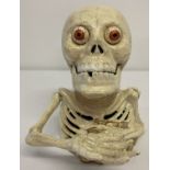 A painted cast metal skeleton mechanical money bank.