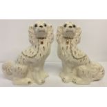 A pair of Staffordshire dog ornaments with gilt detail. Crown mark and 'Made In England' to bases.
