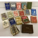 A collection of vintage playing cards, mostly boxed.