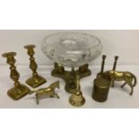 A box of assorted vintage brassware items to include candlesticks and horse figurines.