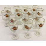 A collection of 14 vintage sherry and liquor glasses with pheasant and gold rim decoration.