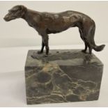A signed bronze figure of a greyhound dog mounted on a rectangular marble base.