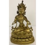 A heavy hollow gilt bronze figurine of an Oriental Deity.