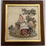 A framed and glazed vintage tapestry depicting a woman in period dress.
