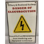 A cast iron wall hanging railway "Danger of Electrocution" sign.