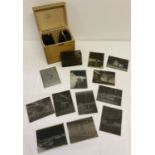 A wooden box containing a quantity of vintage glass negative plates.