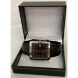 A boxed men's wristwatch by Amadeus with silver tone square case with black dial.