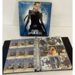 2 folders containing Inkworks Lara Croft Tomb Raider trading cards.