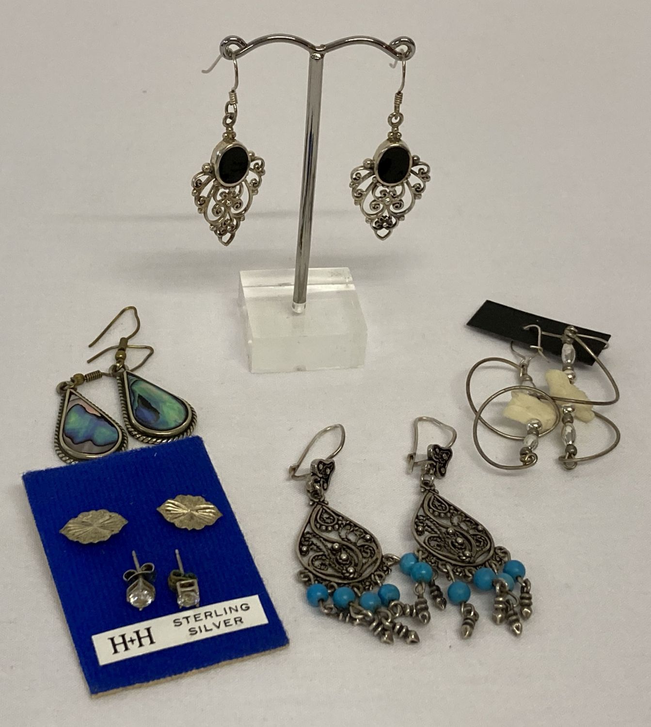 6 pairs of vintage and modern design silver and white metal earrings in both drop and stud styles.