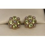 A pair of 9ct gold stud style earring set with Peridots and seed pearls by Luke Stockley, London.