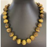 A modern style tigers eye bead necklace with large silver spring clasp.