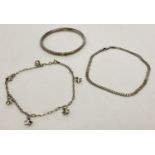 2 silver ankle chains, a curb chain and a decorative chain with star charms.