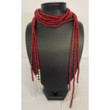 A red coral and pearl 3 strand style necklace. No clasp fixings, can be worn as necklace or belt.