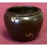 A small Chinese bronze pot with gold splash detail.