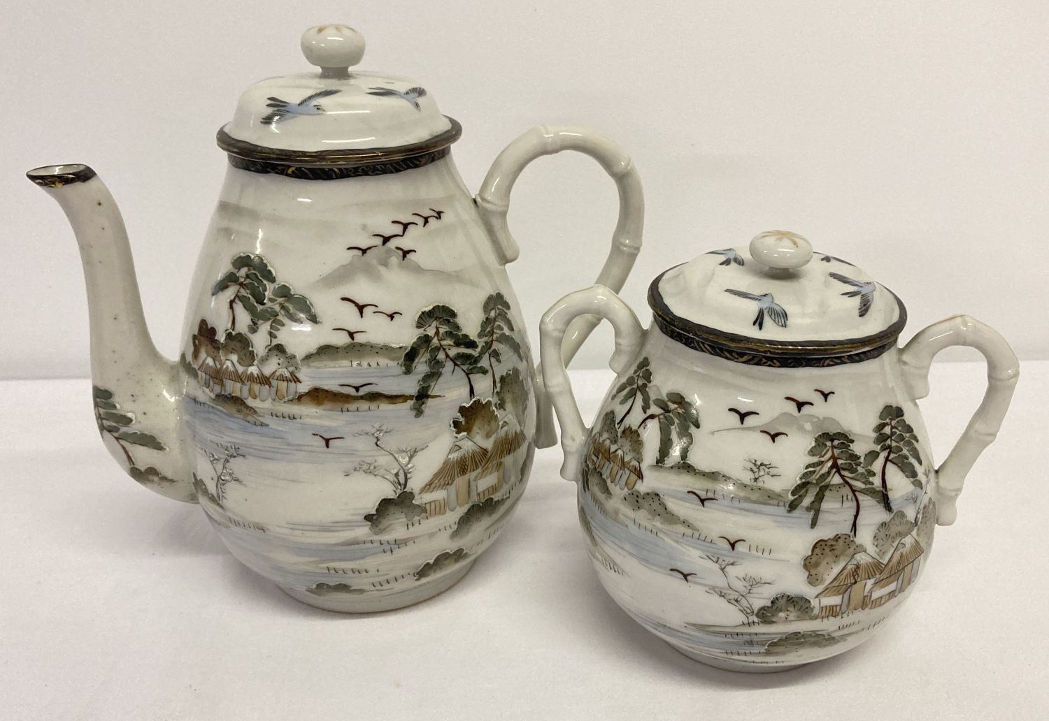 2 pieces of Oriental hand painted ceramics; a coffee pot and a matching 2 handled lidded pot.