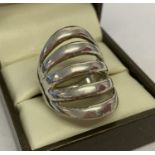 A contemporary design silver dress ring with cut away detail.