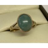 A 9ct gold dress ring set with an oval cabochon of green jade.