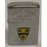 A windproof lighter with engraving in memoriam of the 15th Support Brigade.