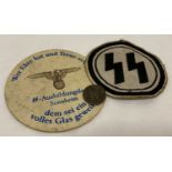 3 German WWII style items. An embroidered sports vest patch and an SS beer mat.