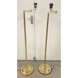 A pair of brass adjustable floor lamps.