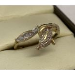 A 9ct gold serpent ring set with 4 small round cut diamonds to eyes and head.