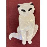 A Lea Stein style black and white pearlised Lucite pin back brooch in the form of a cat.