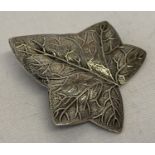 A vintage silver brooch in the shape of an ivy leaf. Marked silver to reverse.