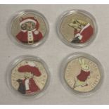 A collection of 4 Beatrix Potter 50p coins all with Christmas sticker decals.