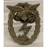 A WWII style German Air Assault pin back badge.