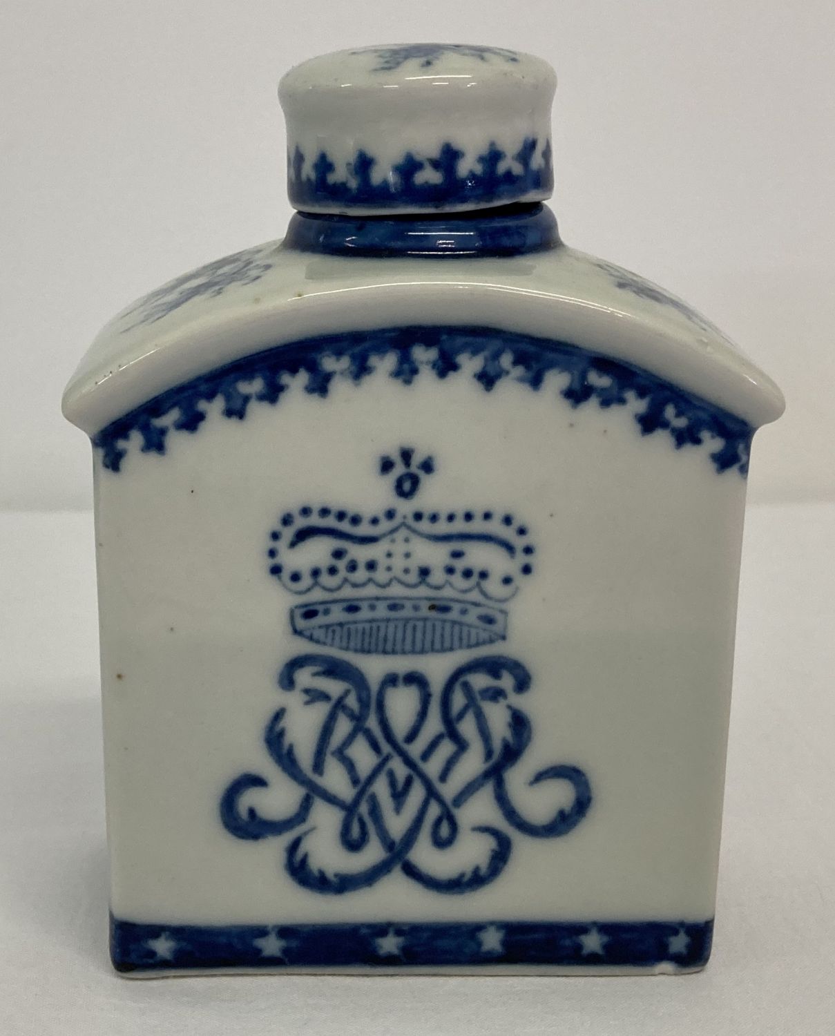A blue and white ceramic oriental tea jar with monogram and crown design to front and back. .