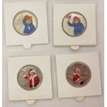 A collection of 4 Paddington Bear 50p coins with sticker decals.