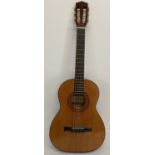 A wooden bodied 6 string acoustic guitar by Hohner.