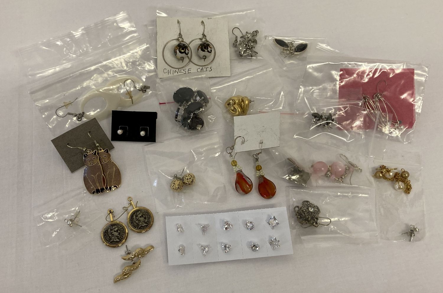 26 pairs of vintage and modern costume jewellery earrings in both drop and stud styles.