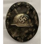 A WWII style German silver award pin back wound badge.