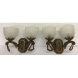 A pair of Art Deco style wall uplighters. Wooden mounts with decorative fittings and glass shades.