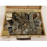 A wooden box containing a quantity of vintage and modern costume jewellery to include diamante.