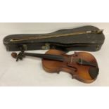 A wooden case violin with bow and carry case. Both violin and bow need new strings.