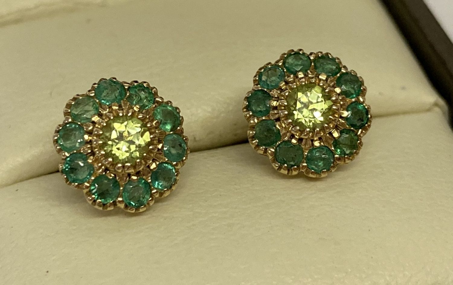 A pair of 9ct gold, emerald and peridot cluster stud earrings by Luke Stockley.