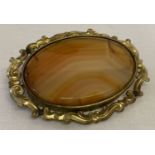 A large vintage oval shaped agate brooch, in decorative gold mount.