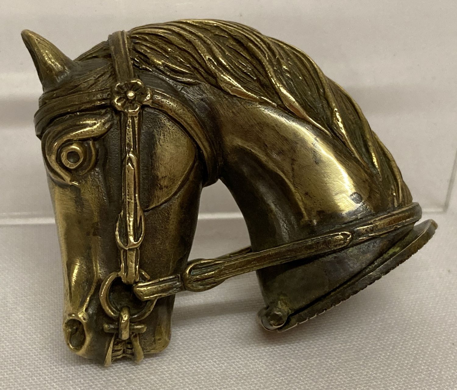 A brass vesta case in the shape of a horses head, with striking panel to hinged lid.