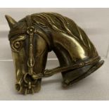 A brass vesta case in the shape of a horses head, with striking panel to hinged lid.