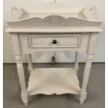 A wooden occasional table with fixed tray style top, central drawer and under shelf.