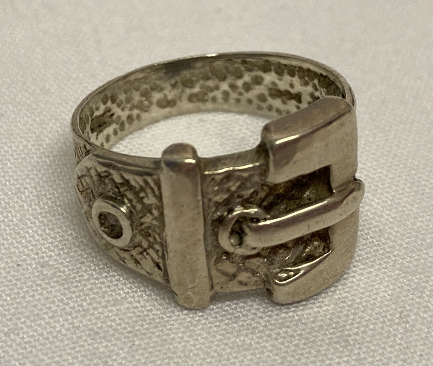 A vintage silver buckle dress ring with diamond shaped decoration.