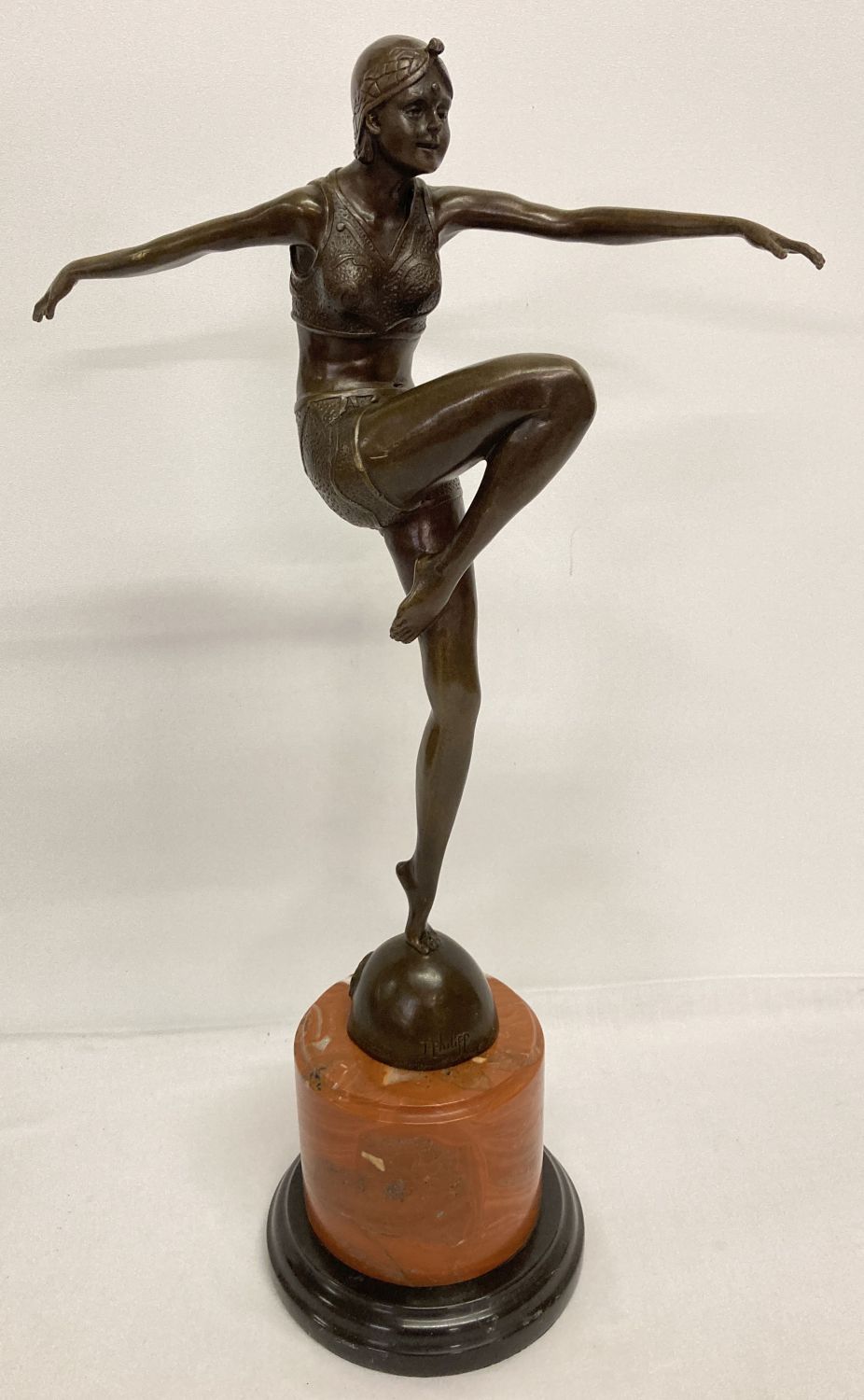 A large Art Deco style bronze figurine of a dancing woman mounted on circular marble plinth.